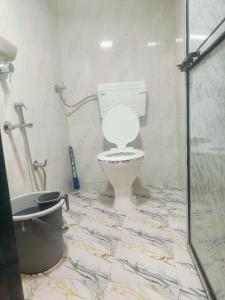 a bathroom with a toilet and a shower at Farhan DORMITORY in Mumbai