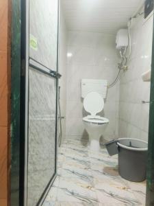 a bathroom with a toilet and a shower at Farhan DORMITORY in Mumbai