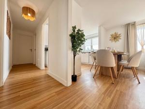a dining room and living room with a table and chairs at Le Nid Doré in Calais
