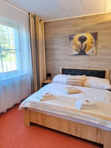 a bedroom with a bed with two towels on it at Wellness Hotel Staré Město in Uherské Hradiště +38 photos