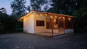 a small house with lights on it at night at Donde Dubon Pandi house in Puerto Jiménez
