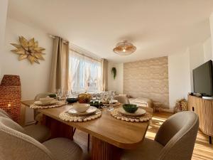 a dining room with a table with wine glasses on it at Le Nid Doré in Calais +11 photos