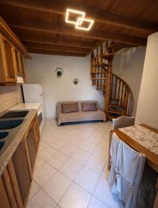 a kitchen with a couch in the corner of a room at Kathryns apartment in Sinarádes