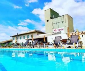 a swimming pool with chairs and a hotel at Hotel Mirante São Brás in São Brás do Suaçuí +44 photos