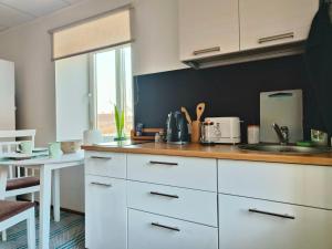 a kitchen with white cabinets and a sink at Tartu tänava külaliskorter in Viljandi +2 photos