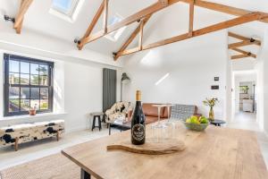 a bottle of wine on a wooden table in a living room at Cosy Nook at Jam Jar Kitchen in Crantock +26 photos
