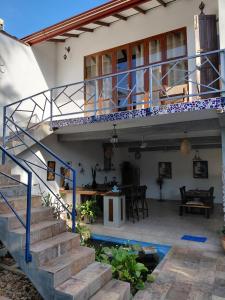 a house with a staircase leading to a patio at Villa Mosaic in Tangalle