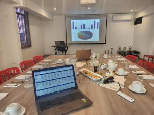 a laptop computer sitting on top of a long table at Hotel Vila Santa in Lima