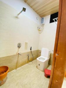 a bathroom with a toilet and a shower at Vishwa Heritage Ellora in Ellora +5 photos