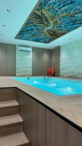 a large swimming pool with a painting on the ceiling at فندق منسي Monsi Hotel in Taif