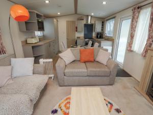 a living room with a couch and a table at Cresswell Towers in Morpeth
