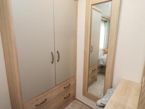 a bedroom with a closet with a mirror at Cresswell Towers in Morpeth