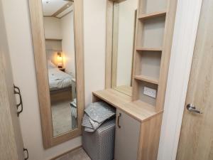 a small room with a mirror and a bedroom at Cresswell Towers in Morpeth