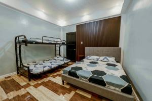 a bedroom with two bunk beds in it at Jhenk's Guesthouse in Coleto