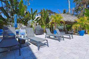 a group of chairs and tables on a patio at The Inn on Siesta Key in Siesta Key
