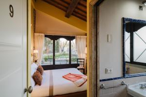 a bedroom with a bed and a bathroom with a mirror at Residenza Il Colle in Impruneta