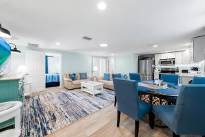 a living room with a table and blue chairs at Star Fish 3 Bed 2 bath POOL Walk to Beach in Sarasota