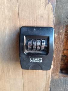 a black electrical outlet on a wooden wall at Ferienwohnung am Kloster in Hornbach
