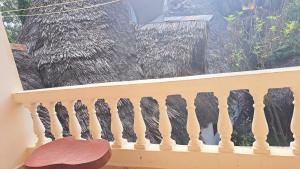 a bird standing on a balcony looking out a window at Diani Haven Swahili modern studio in Kwale