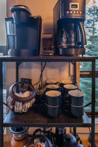 a shelf filled with coffee cups and a microwave at The Icelander at Mammoth Point in Mammoth Lakes