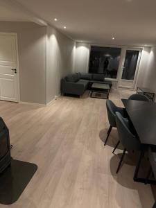 a living room with a couch and a table at Bolig leies ut med 3 soverom in Namsos