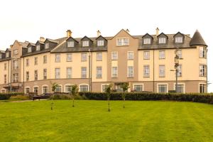 a large building with a lawn in front of it at Portrush Atlantic Hotel in Portrush