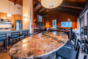 a large wooden table in a room with chairs at The Icelander at Mammoth Point in Mammoth Lakes +73 photos