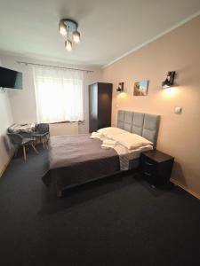 a bedroom with a bed and a desk in it at Leniwy Motyl in Rajcza +52 photos