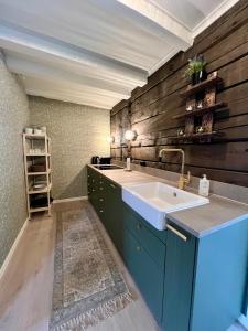 a bathroom with a sink and a wooden wall at Stryn - house by the river in Stryn +29 photos