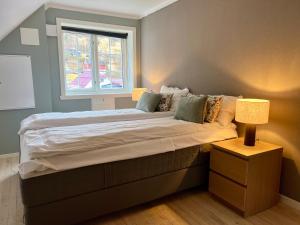 a bedroom with a large bed with a window at Stryn - house by the river in Stryn