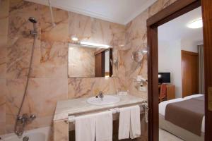 a bathroom with a sink and a mirror at Hotel Principe Paz in Santa Cruz de Tenerife +52 photos