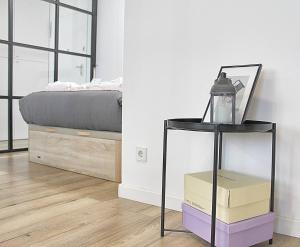 a bedroom with a bed and a side table at Arrábida Luxury Studio in Vila Nova de Gaia
