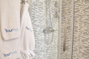a bathroom with a shower with a white towel at Arrábida Luxury Studio in Vila Nova de Gaia +24 photos