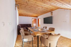 a dining room with a wooden table and chairs at Кума Лиса in Devin