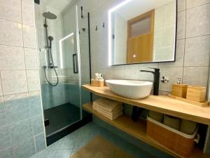 a bathroom with a sink and a shower at Apartmani Perić in Stari Grad