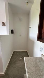 an empty room with white walls and a concrete floor at villa coqueiro praia do prea in Cruz