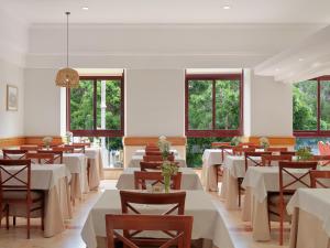 a dining room with tables and chairs and windows at Hotel Principe Paz in Santa Cruz de Tenerife