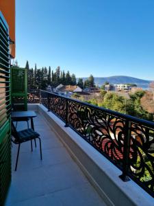 a balcony with a table and a bench on it at Villa AdriaBelle in Tivat