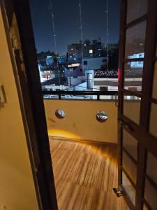 an open door to a balcony with a wooden floor at Hotel Maharaja Path in Ujjain