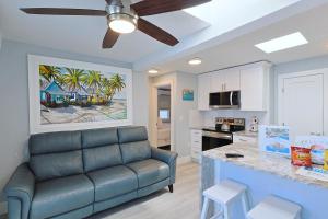 a living room with a couch and a kitchen at The Inn on Siesta Key in Siesta Key