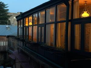 a house with windows on the side of it at Hotel Commune 1889 in Kutaisi