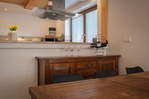 a kitchen with a counter with wine glasses on it at Tatry TOP Dom in Vavrišovo