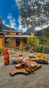 a table with bread and food on a table at Cabaña Bachué in Sutatausa
