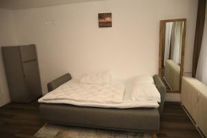 a bed in a room with a white mattress at Maison-Home-ZuHause in La Calamine