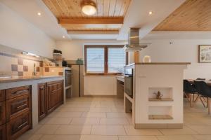 a large kitchen with a large island in the middle at Tatry TOP Dom in Vavrišovo