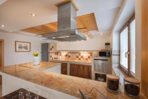 a kitchen with a large island with a stove at Tatry TOP Dom in Vavrišovo