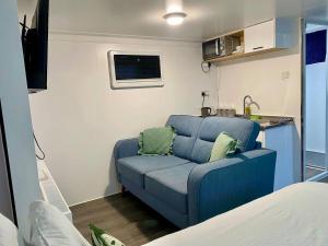 a living room with a blue couch in a caravan at The Lux Pod in Ballynameen