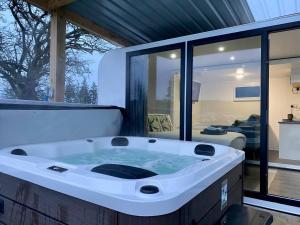 a jacuzzi tub in the middle of a house at The Lux Pod in Ballynameen +34 photos