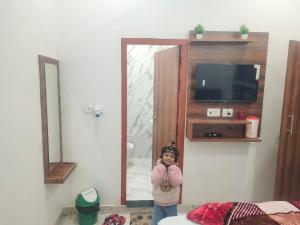a little girl is standing in a room at Pushpkali Seva Sadan in Mathura