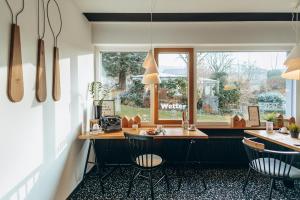 a kitchen with a table and chairs and a window at Hotel Scholz in Aalen